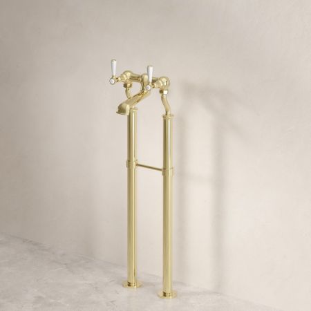 Linton Floor Mounted Bath Filler with 620mm Standpipes & White Levers in Timeless Brass