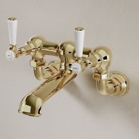 Linton Wall Mounted Bath Filler with White Levers in Timeless Brass