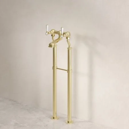 Linton Classic Floor Mounted Bath Filler with 620mm Standpipes & White Levers in Timeless Brass